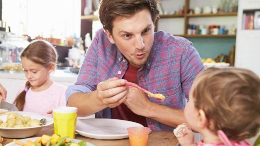 man feeding baby